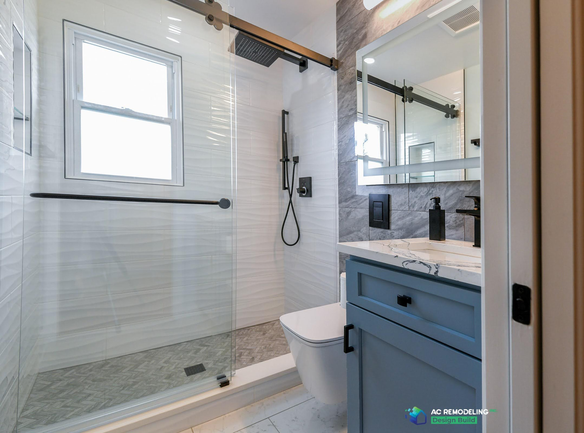 Compact bathroom with a window in the shower and a ceiling exhaust fan above the vanity