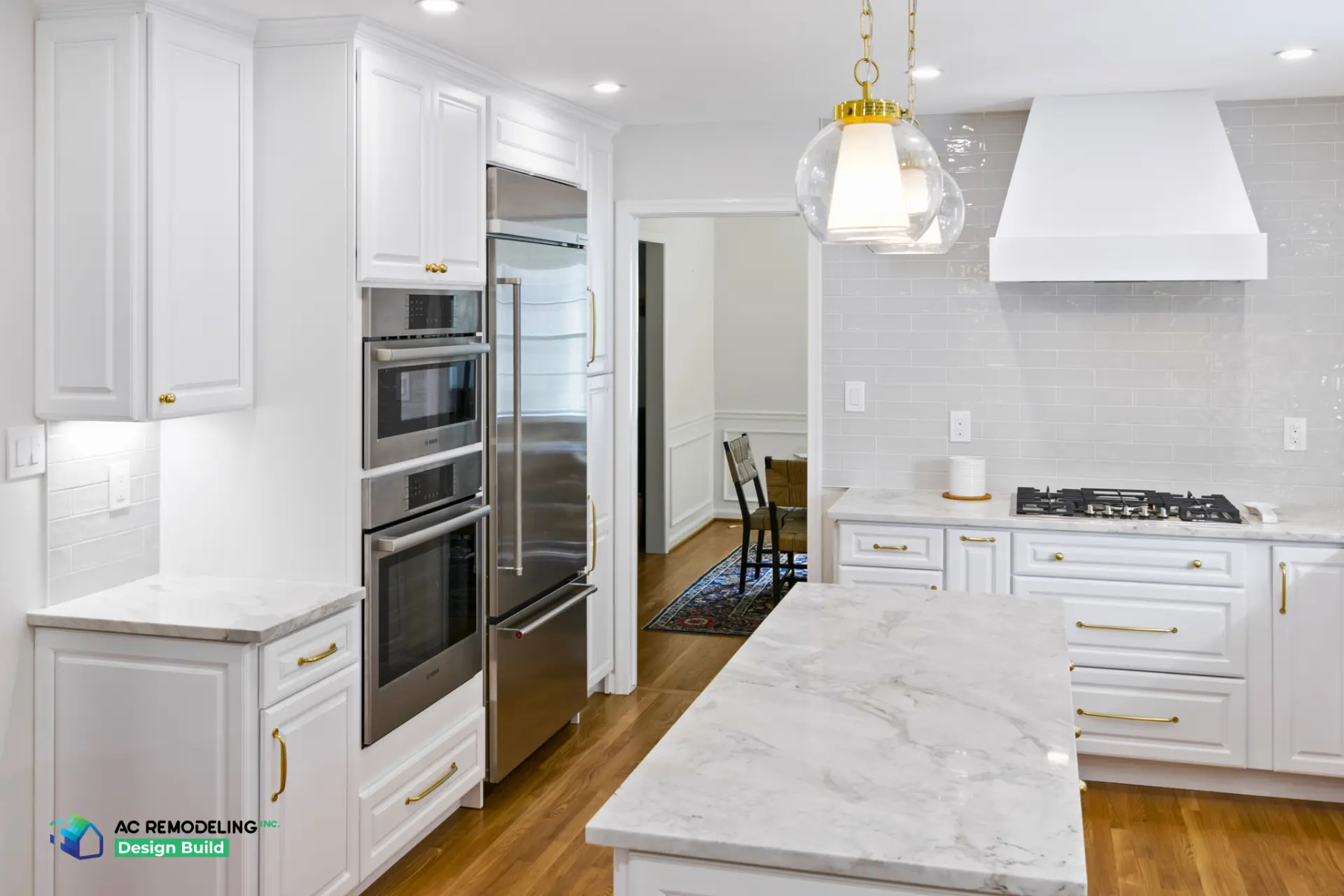 Bosch wall ovens and white vent hood over cooktop