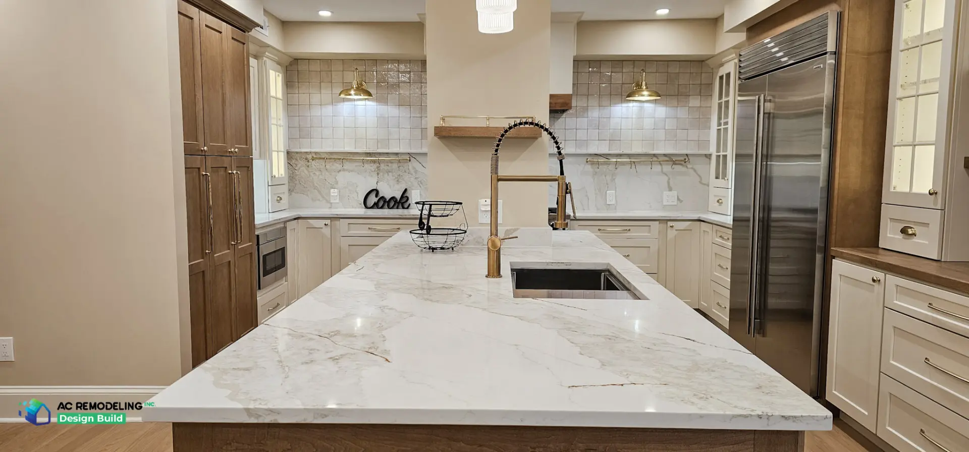 Quartzite island with brass gooseneck faucet and workstation sink