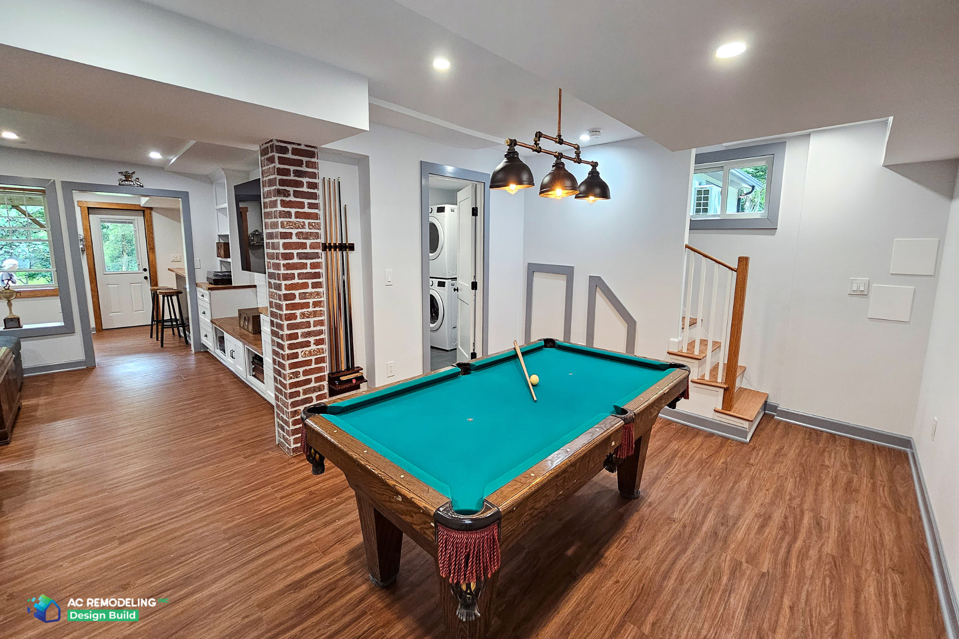 Indoor jungle gym in a finished basement with climbing ropes, monkey bars, and soft seating areas — a creative example of basement playroom ideas for kids.