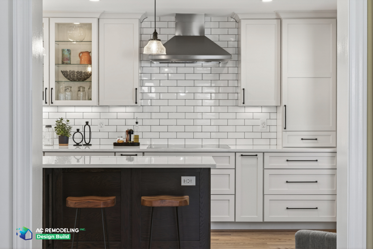 Cooking wall framed by white cabinets with island stools in the foreground