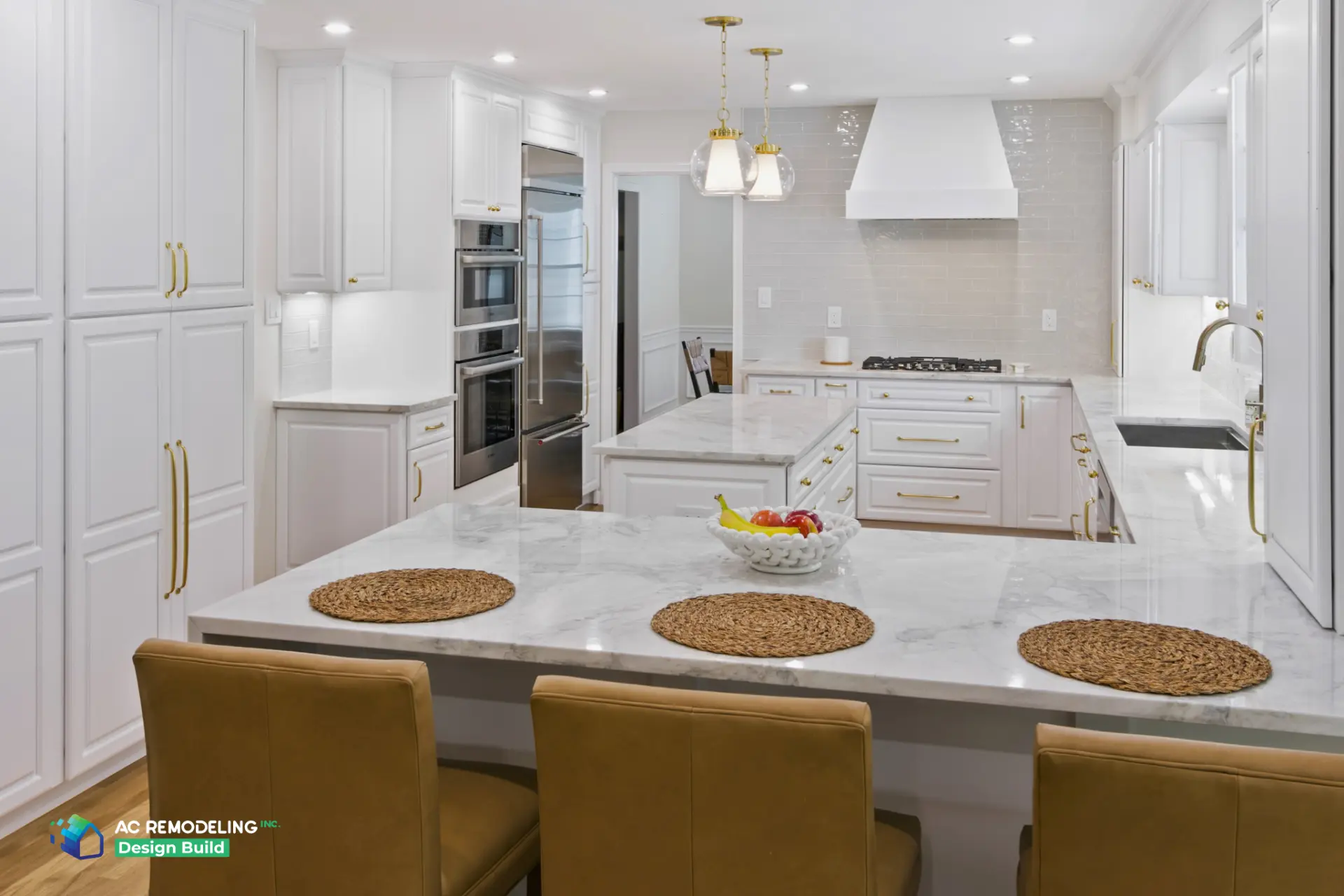 Kitchen with glass pendants and marble waterfall counter