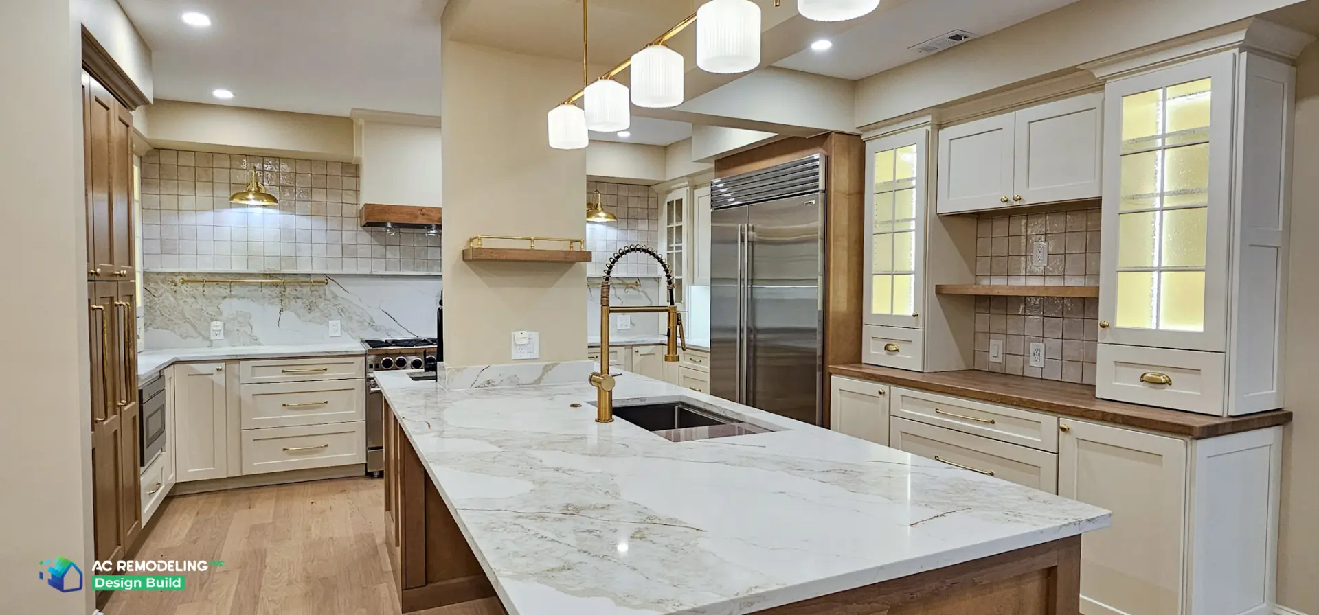 Open kitchen with large quartzite island, fluted pendants and stained wood base