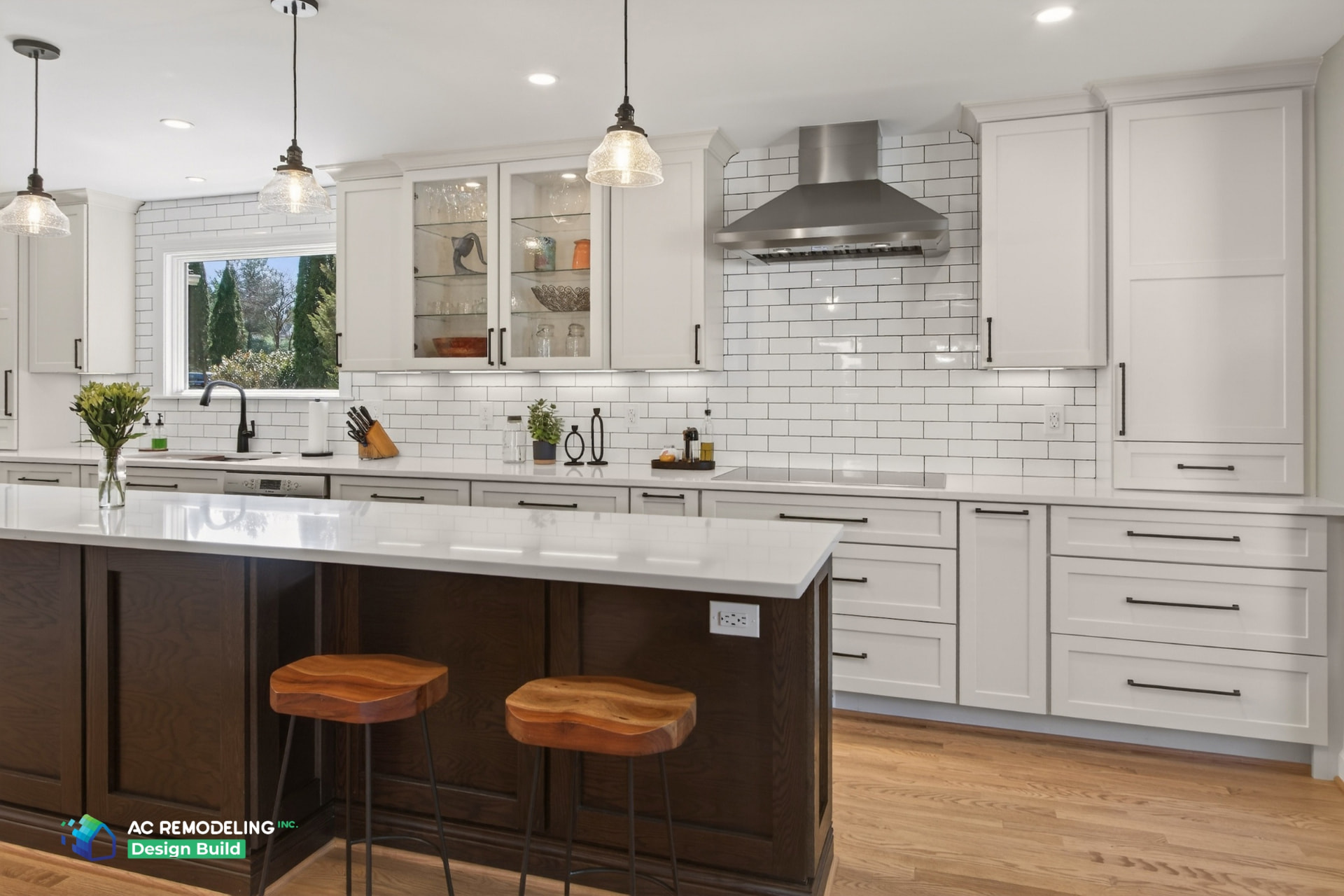 Island seating with live-edge wood stools beneath the stainless hood and subway tile wall