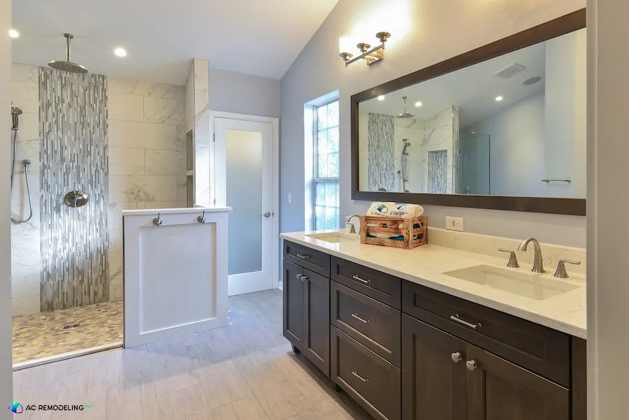 In a luxurious master bathroom, a circular rain shower head is positioned in the center, providing a striking focal point. This bathroom design excludes a bathtub and includes a generously sized dual sink vanity area, offering both style and functionality.