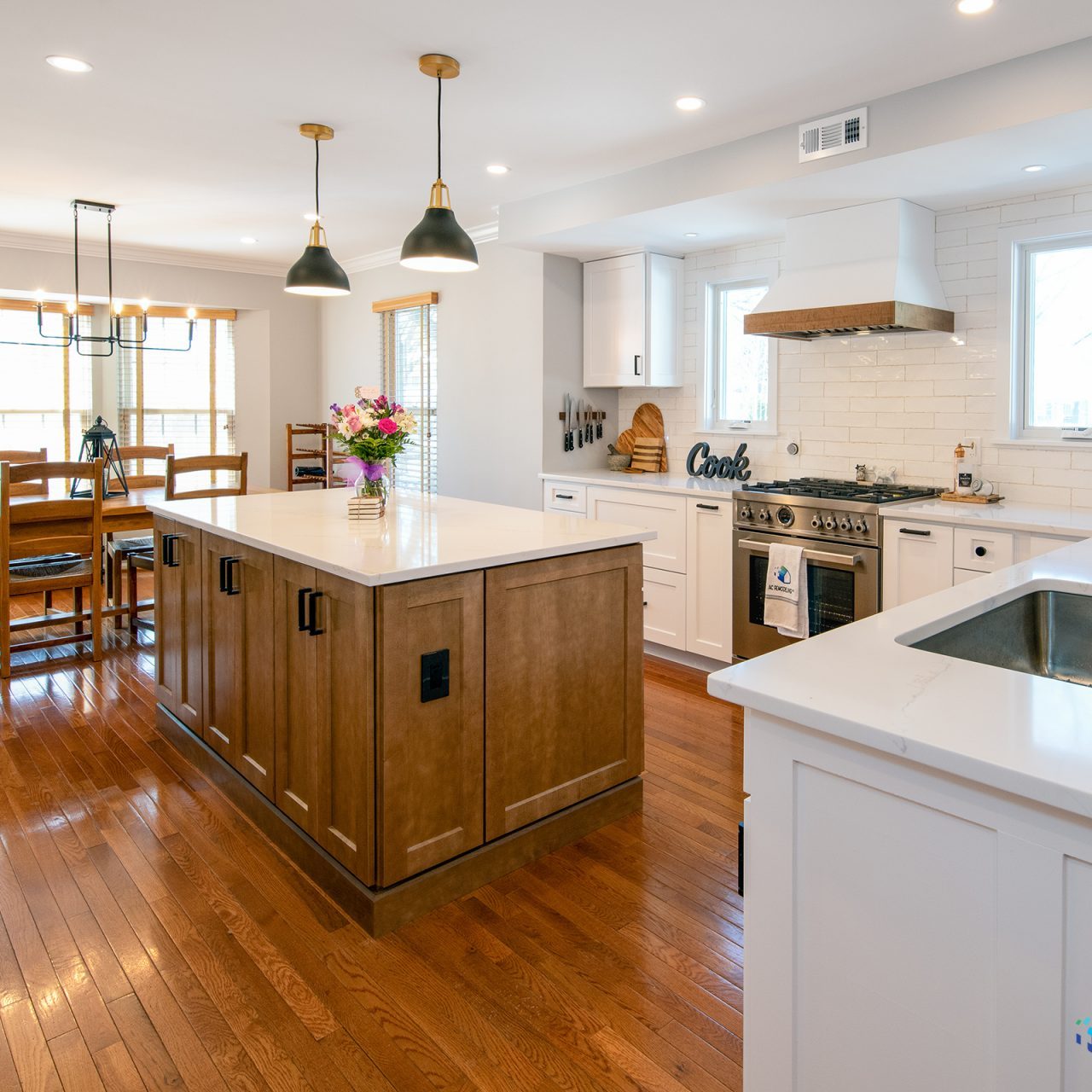 An upgraded kitchen and dining room with polished wooden floors, offering a warm and inviting atmosphere